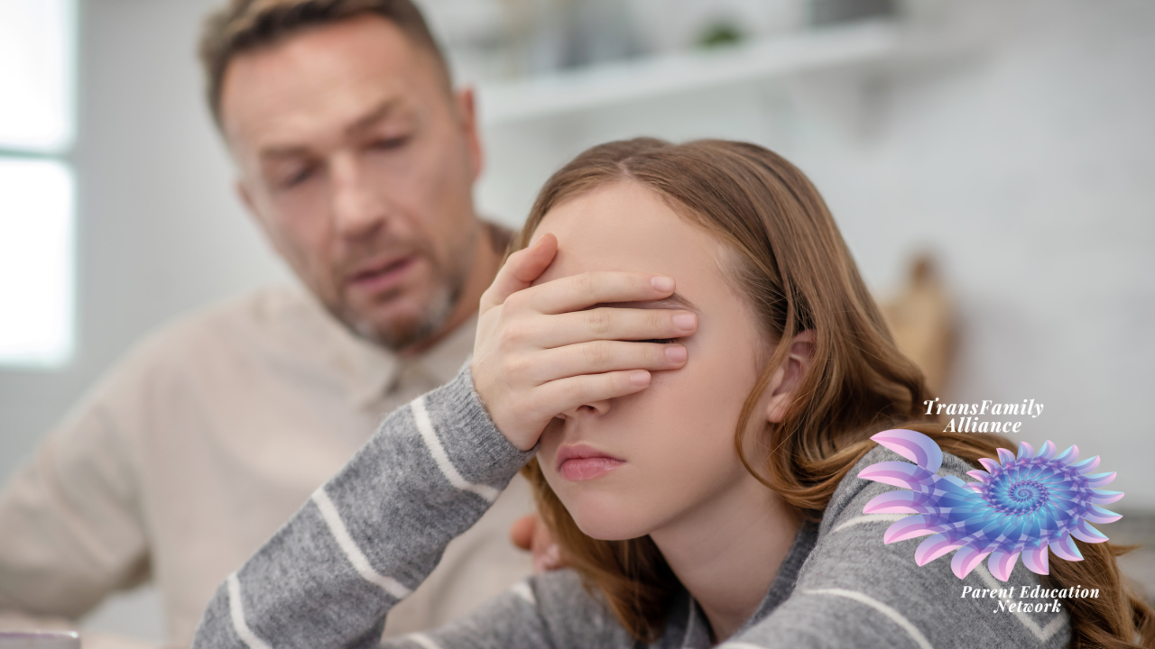 Disgruntled teen in foreground covering eyes to avoid eye contact with defensive parent in background who is stumbling through a discussion regarding using proper gender pronouns or using the right terminology with your trans child