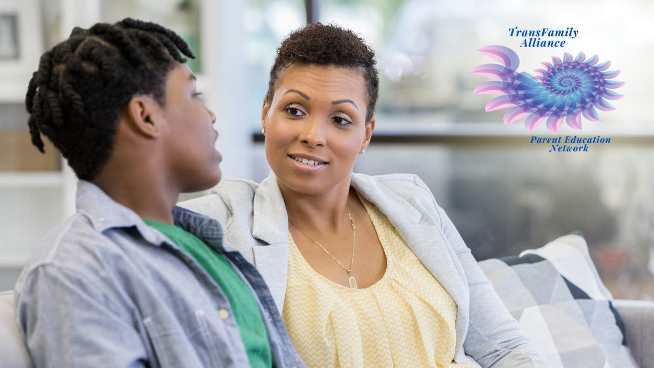 Parent sitting side-by-side with youth, presumably her child, having a conversation about the decisions to be made for the youth's gender affirming care