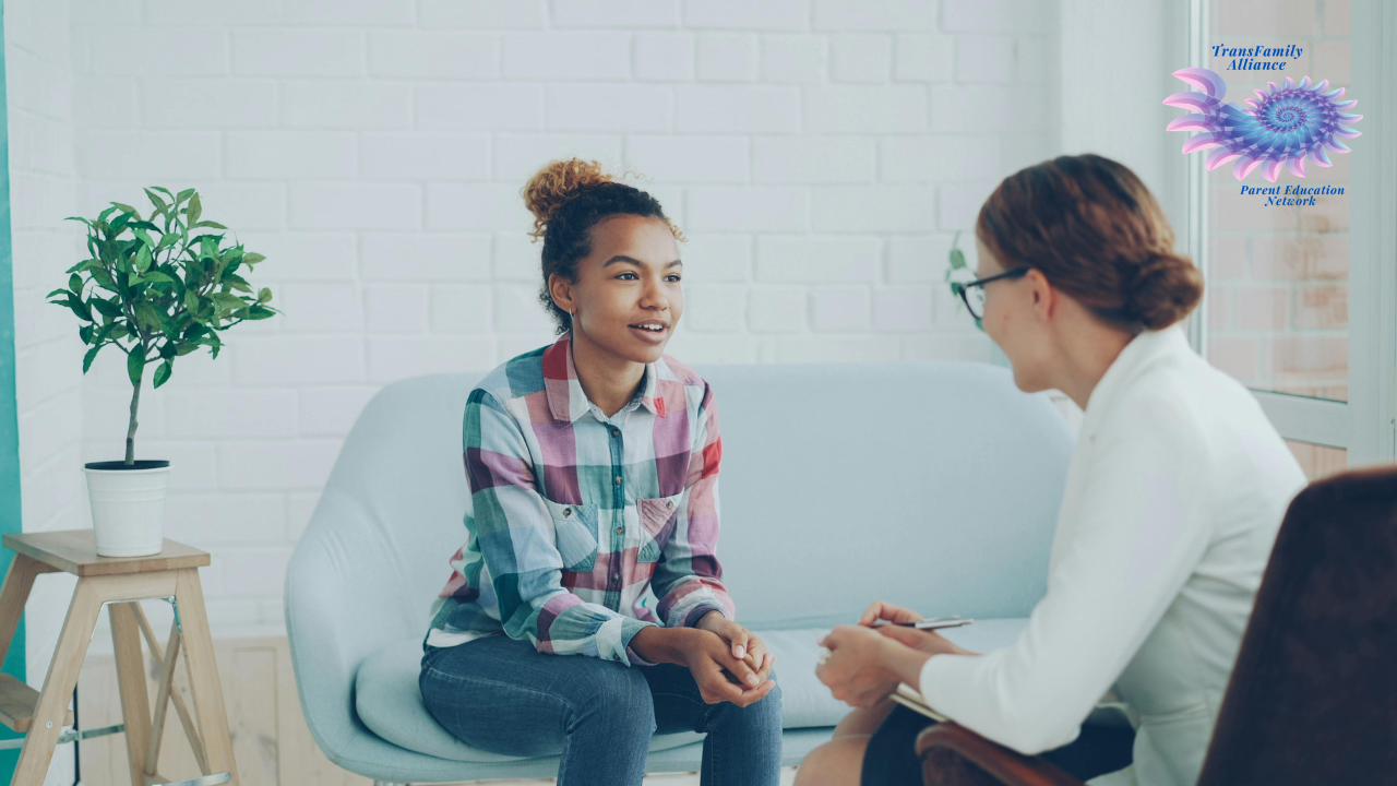 Young person sitting on couch with a therapist, getting real answers to their question, What is Gender Affirming Care?