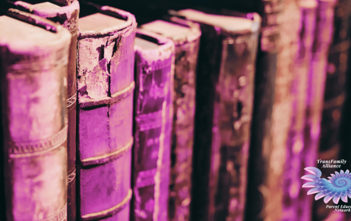 Upclose, textured view of antique books overlaid with a pinkish filter, used for promoting our upcoming event: Trans History for Troubled Times: An Educational Workshop for Friends and Family