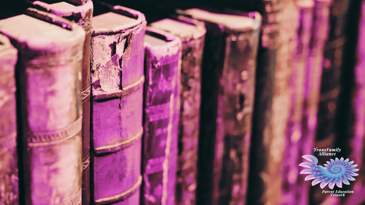 Upclose, textured view of antique books overlaid with a pinkish filter, used for promoting our upcoming event: Trans History for Troubled Times: An Educational Workshop for Friends and Family